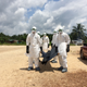 A local burial team is getting ready to remove the body of a woman who died of Ebola in a village in Margibi County.
